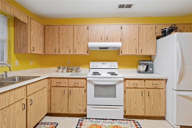 kitchen featuring light brown cabinets, white appliances, sink, and light tile patterned floors