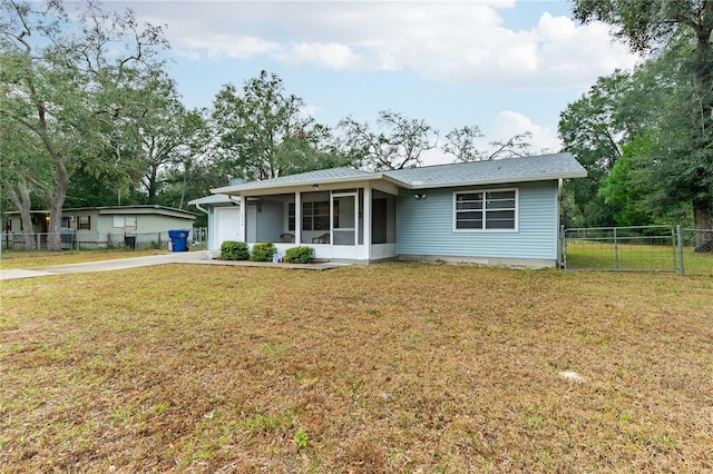 ranch-style home with a garage and a front lawn