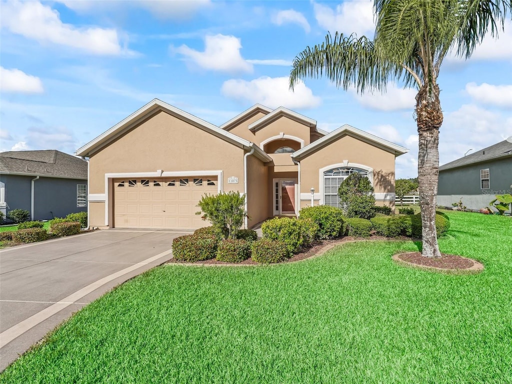 view of front facade with a garage and a front lawn