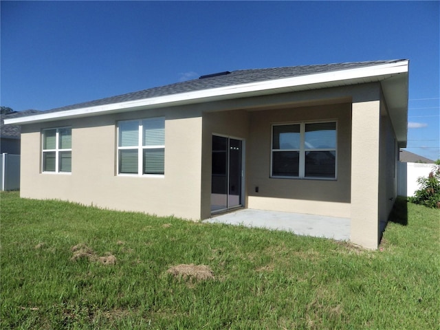 rear view of property with a lawn