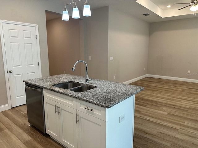 kitchen featuring sink, white cabinetry, dishwasher, an island with sink, and dark stone counters