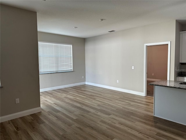 unfurnished living room with hardwood / wood-style flooring