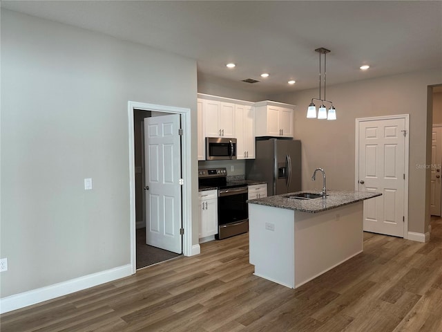 kitchen featuring white cabinetry, appliances with stainless steel finishes, sink, and a kitchen island with sink