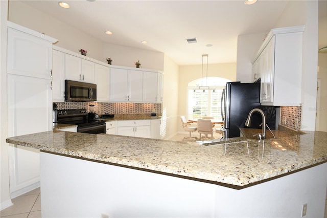 kitchen featuring kitchen peninsula, light stone counters, white cabinets, and stainless steel appliances