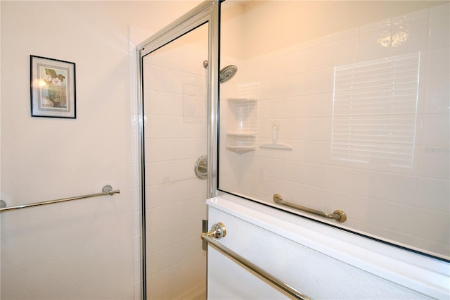 bathroom with a shower with door