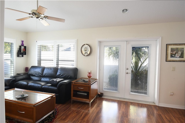 living room featuring dark wood-type flooring, ceiling fan, french doors, and a healthy amount of sunlight