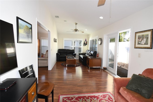 living room with ceiling fan, dark wood-type flooring, and vaulted ceiling