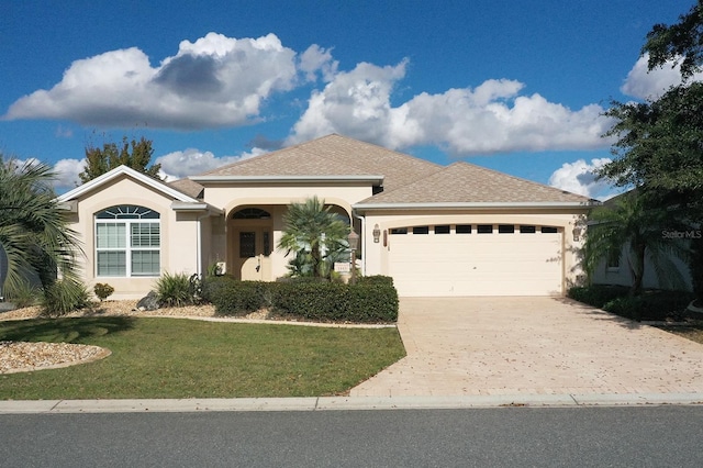 ranch-style house featuring a front yard and a garage