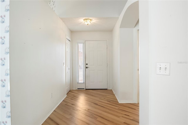 interior space featuring a textured ceiling and light wood-type flooring