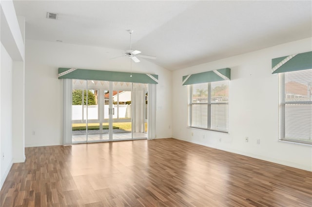 empty room featuring hardwood / wood-style flooring, ceiling fan, and vaulted ceiling