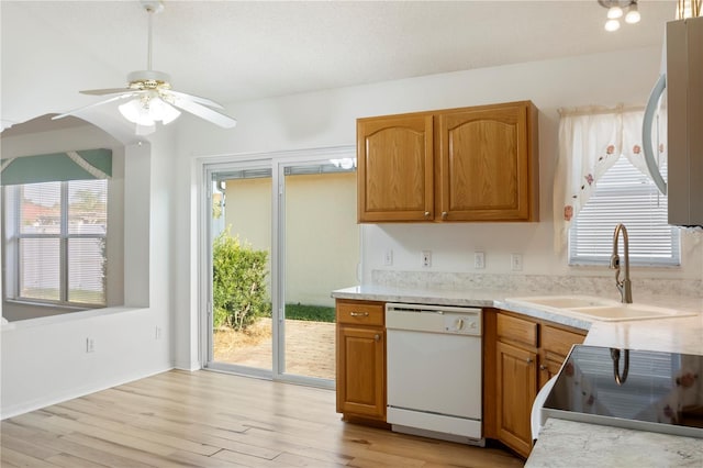 kitchen with light wood-type flooring, ceiling fan, sink, dishwasher, and range