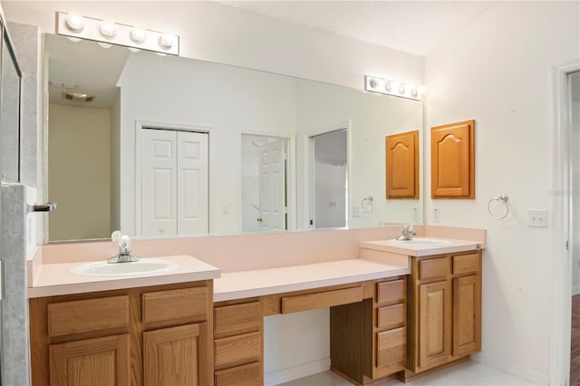 bathroom with a textured ceiling and vanity