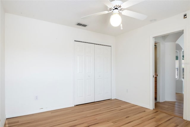 unfurnished bedroom featuring a closet, light hardwood / wood-style floors, and ceiling fan