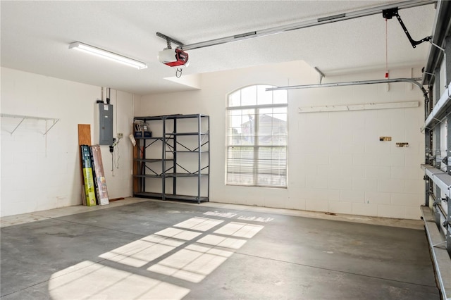 garage featuring electric panel and a garage door opener