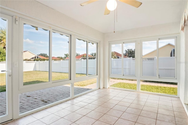 unfurnished sunroom with ceiling fan and a healthy amount of sunlight