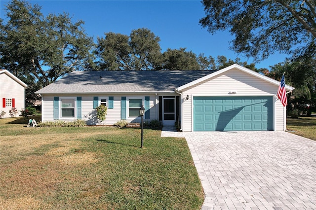 single story home featuring a garage and a front lawn