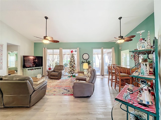 living room with light wood-type flooring and lofted ceiling