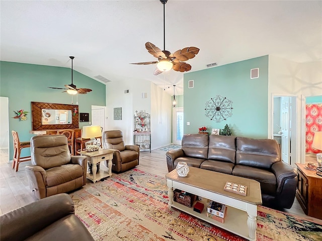 living room with lofted ceiling and light wood-type flooring