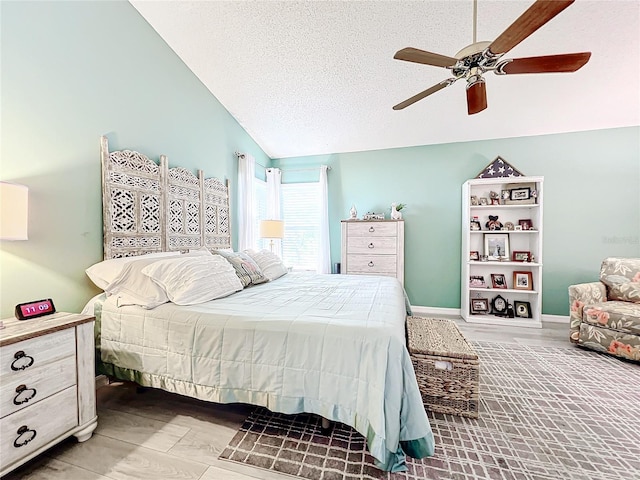 bedroom featuring ceiling fan, a textured ceiling, and vaulted ceiling