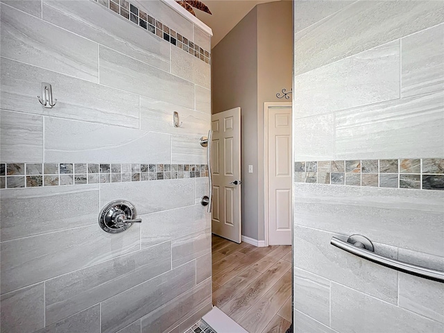 bathroom with wood-type flooring and walk in shower