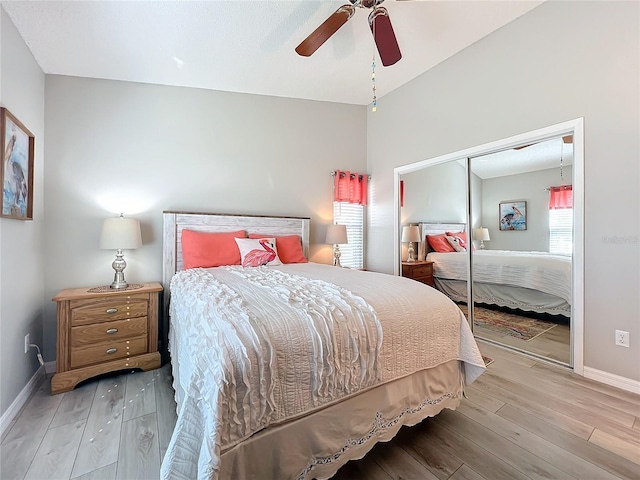 bedroom featuring ceiling fan, light hardwood / wood-style flooring, and a closet