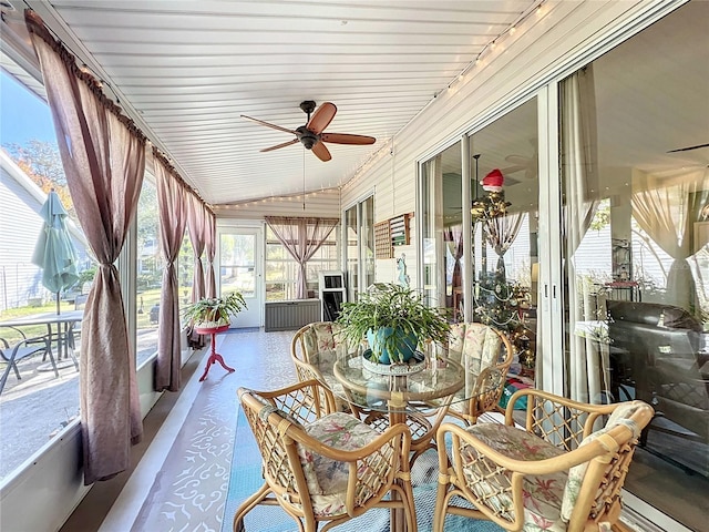 sunroom / solarium featuring ceiling fan and lofted ceiling