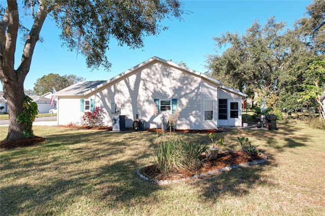 back of property featuring a lawn