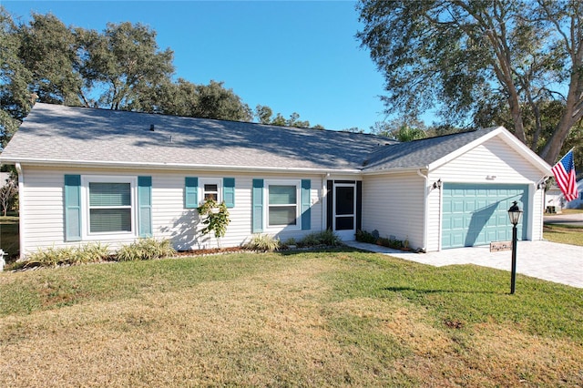 ranch-style house featuring a garage and a front yard