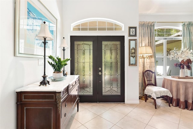 foyer featuring french doors and light tile patterned floors