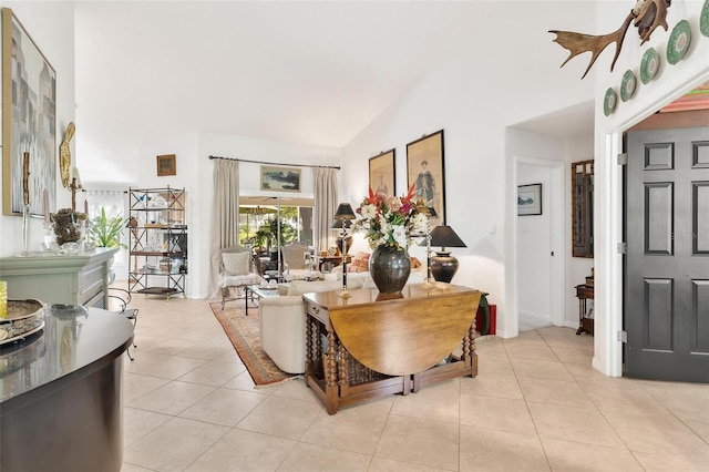 living room with lofted ceiling and light tile patterned floors