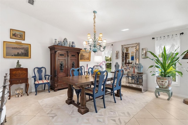 tiled dining area featuring an inviting chandelier