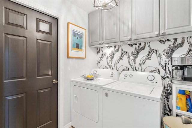 washroom with washing machine and clothes dryer and cabinets