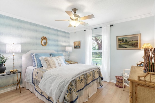 bedroom featuring light hardwood / wood-style floors, ceiling fan, and ornamental molding