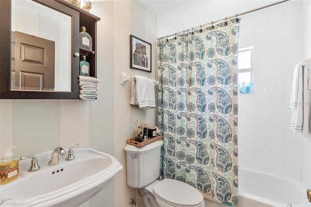 full bathroom featuring sink, shower / tub combo, and toilet