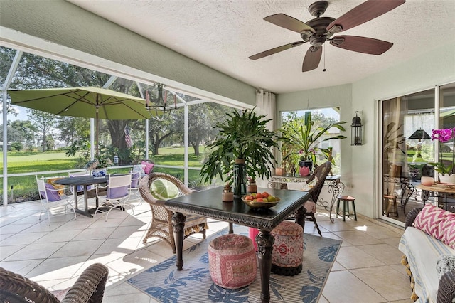 sunroom featuring ceiling fan