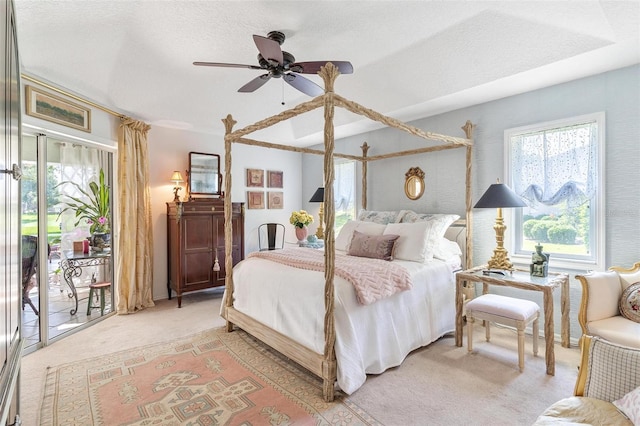 carpeted bedroom featuring ceiling fan, a textured ceiling, and access to outside