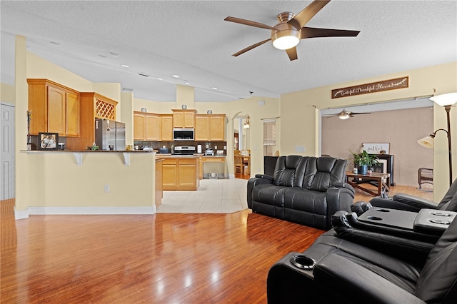 living room featuring a textured ceiling and light hardwood / wood-style flooring