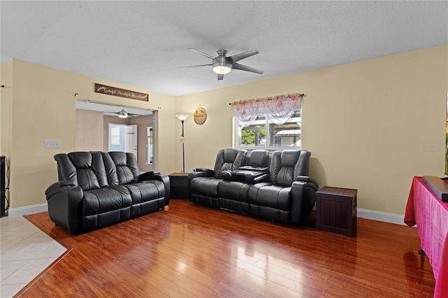 living room with hardwood / wood-style floors and a textured ceiling