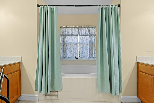 bathroom featuring tile patterned flooring, shower / bath combination with curtain, and vanity