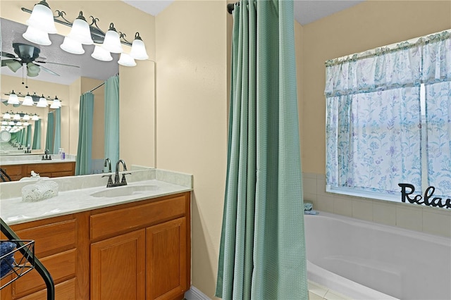 bathroom with a bathing tub, ceiling fan, and vanity