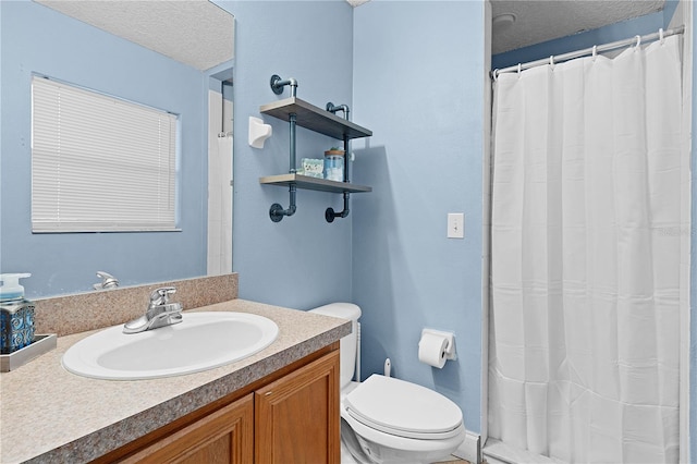 bathroom with vanity, a textured ceiling, and toilet