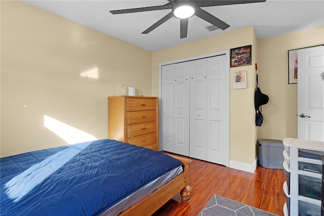 bedroom with a closet, ceiling fan, and dark hardwood / wood-style flooring