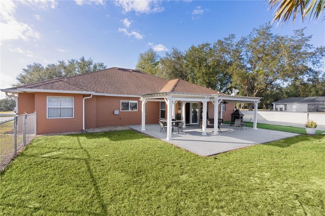 back of property featuring a yard and a patio area