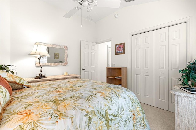 carpeted bedroom featuring ceiling fan, vaulted ceiling, and a closet