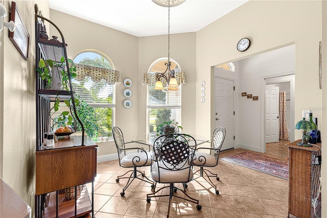 dining area featuring a chandelier, a healthy amount of sunlight, and light tile patterned flooring