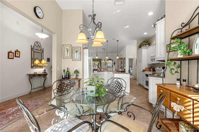 dining room featuring a chandelier and light tile patterned floors