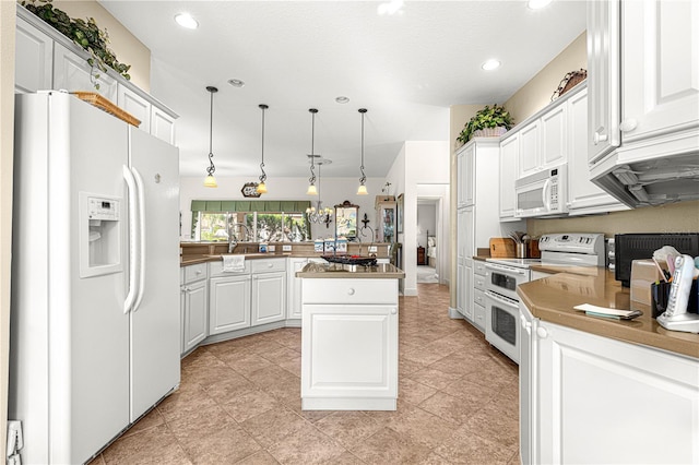 kitchen with white appliances, white cabinets, decorative light fixtures, a kitchen island, and kitchen peninsula