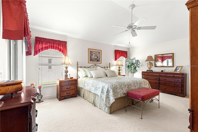 bedroom featuring ceiling fan and light carpet