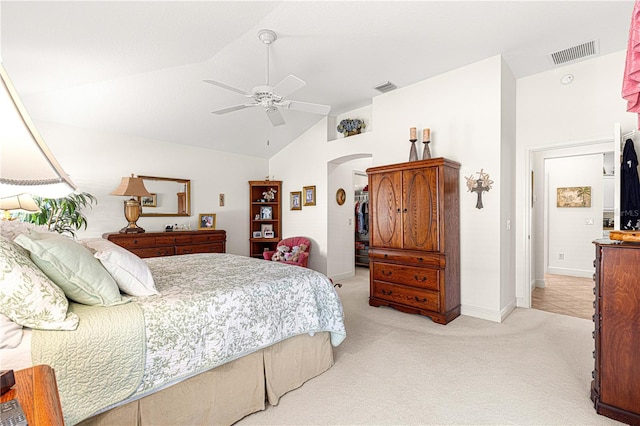 bedroom with ceiling fan, light carpet, and vaulted ceiling