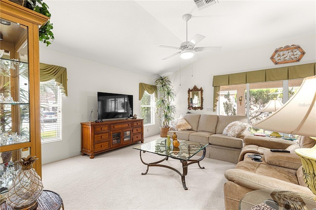 living room featuring plenty of natural light, lofted ceiling, and light carpet